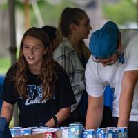 male and female gvsu students talking at a community table